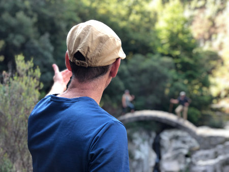 photo of man looking on Roman bridgeの写真素材