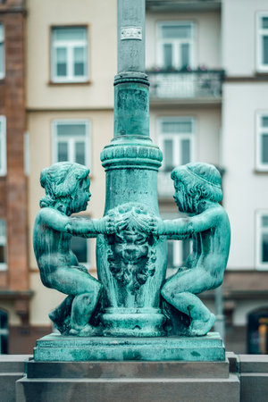 A vertical shot of an old two kids fountain sculpture in Frankfurt, Spainの写真素材