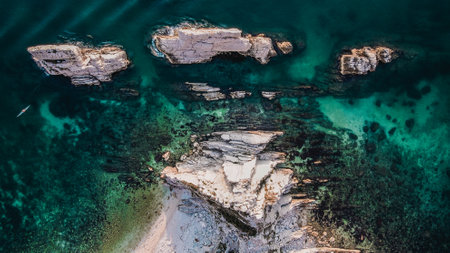 A beautiful landscape aerial scene of rocky formations in the majestic blue water from a high mountainの写真素材