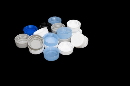 A closeup of Plastic bottle caps on black background