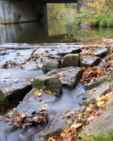 A vertical close-up of water flowing over the rocks