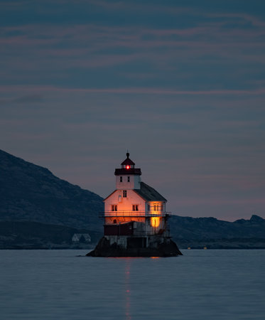 A vertical shot of an old lighthouse in little island in Norwayの写真素材