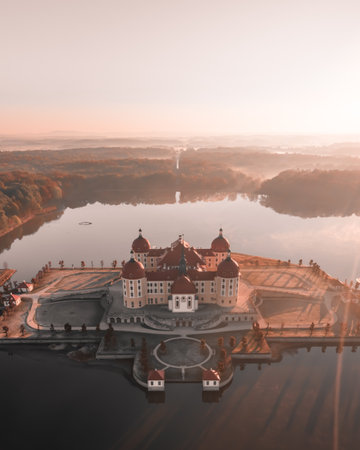 An aerial view of a building near a la in autumnの写真素材