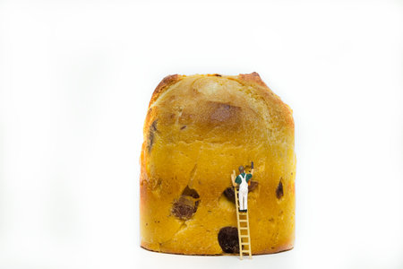 The miniature painter with an Italian Christmas biscuit called panettone isolated on white background.の写真素材