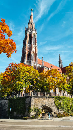 A vertical shot of a church in Munich old town in autumnの写真素材