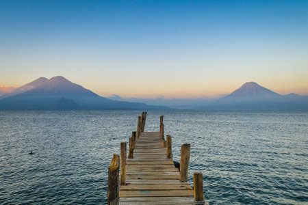 A beautiful shot of a pier on a sea during the sunsetの写真素材