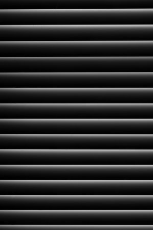 A vertical shot of white stripes isolated on a dark background
