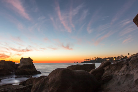 A beautiful view of a beach full of huge rocks in the sunset.の写真素材