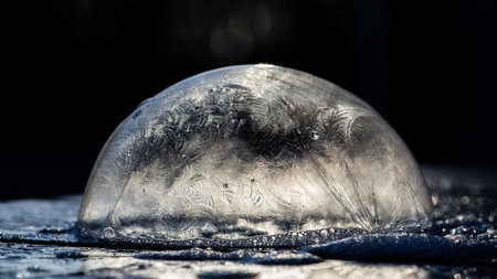 A closeup of a frozen bubble on a dark backgroundの写真素材