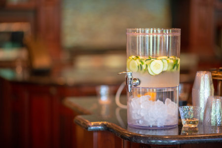 A closeup of water with cucumber on the tableの写真素材