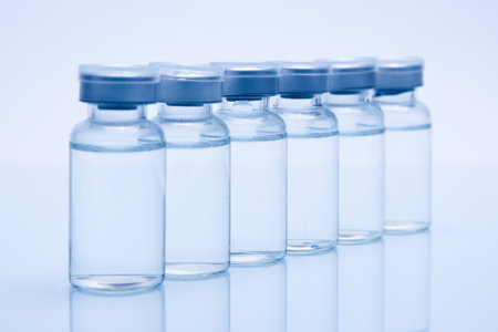 A closeup of medicine or injection vials in a row isolated on a white backgroundの写真素材