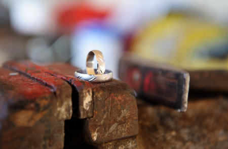 A closeup shot of the wedding rings on the blacksmith stoneの写真素材