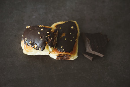 A closeup shot of eclairs on the wooden background