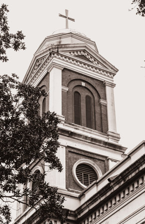 A low angle of a church tower against the sky in monochrome colorsの写真素材
