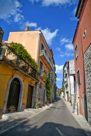 A narrow street surrounded by buildings in SanLorenzello, Benevento province, Italyの写真素材