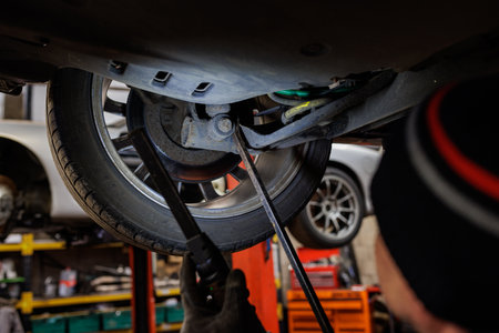 a photo of man fixing carの写真素材