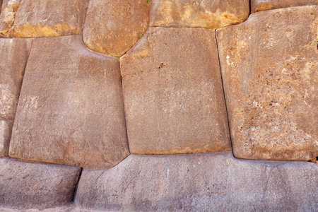 A closeup shot texture of big old stones wall in Inca, Lima, Peru on a sunny dayの写真素材