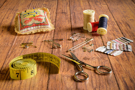 A set of sewing accessories on wooden background