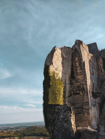 A vertical closeup shot of a giant cliff against a blue skyの写真素材