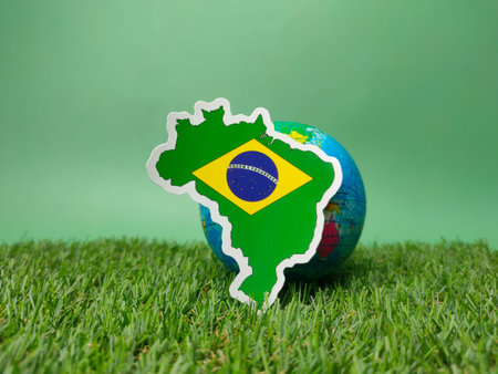 An AI generated illustration of Brazil's flag on a globe on a football fieldの素材