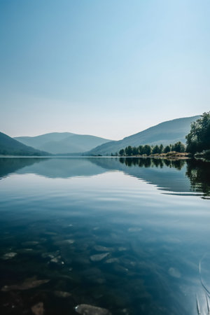 An AI generated illustration of a tranquil lake surrounded by lush green hillsの素材
