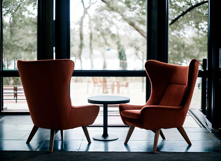 An AI generated illustration of a cozy living room with two chairs situated near a large windowの素材