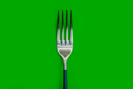 An AI generated illustration of a fork on green background, copy spaceの素材