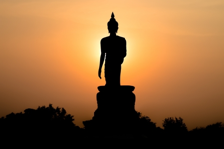 Statue of buddha at sunset silhouetteの写真素材