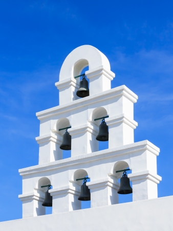 White bell tower santorini style with clear blue skyの写真素材