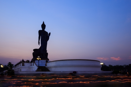Candle light trail of buddhism ceremony at twilight,  walking with lighted candles in hand around buddha statueの写真素材