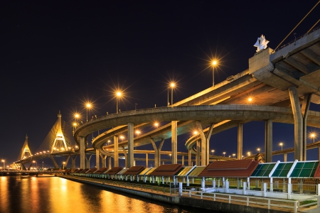 Curve of expressway by river in Bangkok at nightの写真素材