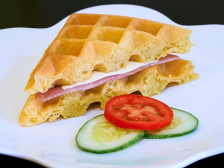 Waffles with ham and cheese on a plateの写真素材