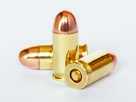 Three 9 mm or .357 bullet on white backgroundの写真素材