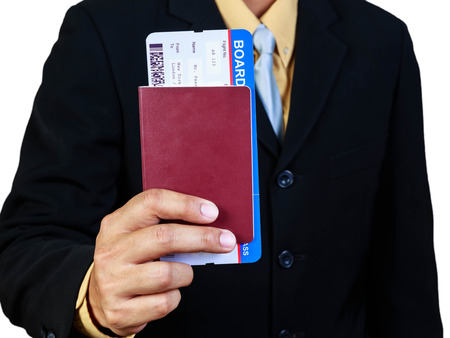 Businessman holding passport and boarding pass concept business travelの写真素材
