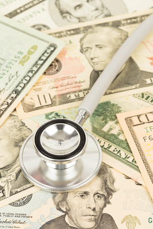Stethoscope on dollar banknote concept financial health checkの写真素材