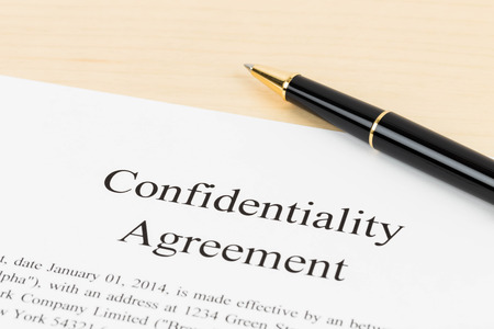 Confidentiality agreement document with pen close-upの写真素材