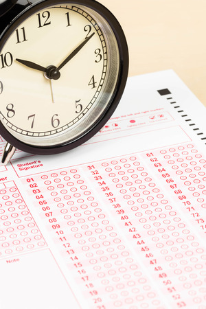 Answer sheet with alarm clockの写真素材