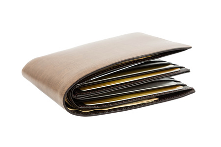 Money in brown leather wallet full of cards on white backgroundの写真素材