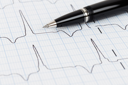Pen on cardiogram concept for heart diagnostic