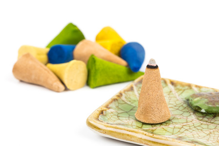 Burning incense cone on plateの写真素材