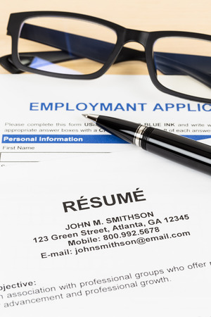Resume with pen and glasses concept job applying; documents are mock-upの写真素材