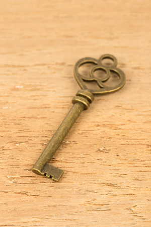 Antique key on wooden backgroundの写真素材