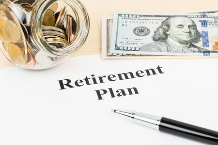 Retirement plan with banknote, coin jar, and penの写真素材