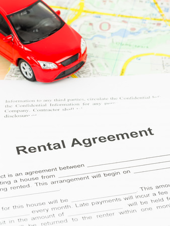 Car rental agreement on map, document is mock-upの写真素材