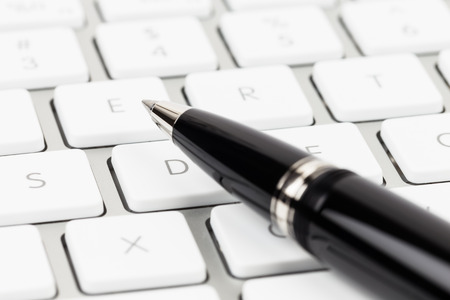 Pen on keyboard concept blog writerの写真素材