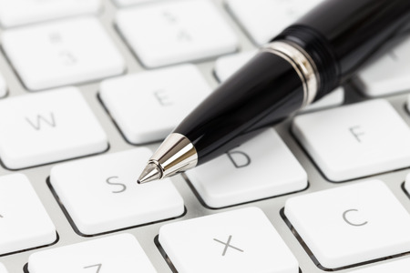 Pen on keyboard concept blog writerの写真素材