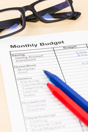 Home budget planning sheet with pen and glassesの写真素材