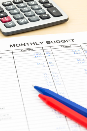 Home budget planning sheet with pen and calculatorの写真素材
