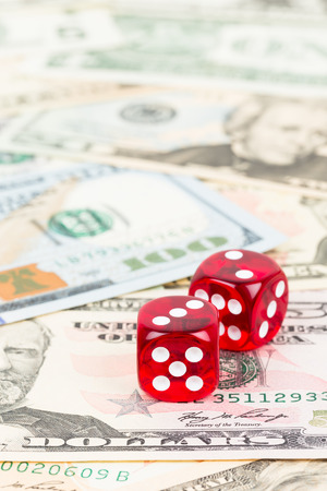 Two dice and dollar bank note concept for risk in investmentの写真素材