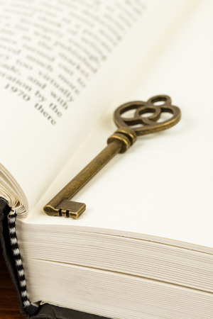 Antique key on book pageの写真素材